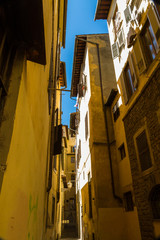 Fototapeta na wymiar Looking up in Narrow Street, Florence Italy.