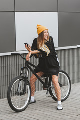 Girl in hockey jersey style with street bicycle