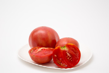 Fototapeta na wymiar fresh sliced homegrown tomato tomatoes on plate