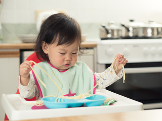 baby girl eating at home