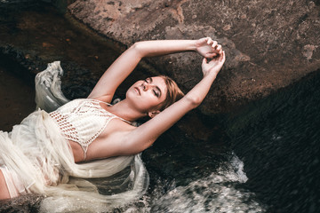 Portrait of a young beautiful girl in the water