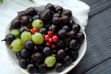 Plate with blackcurrants and gooseberries 