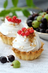 Delicious cakes with cream and berries