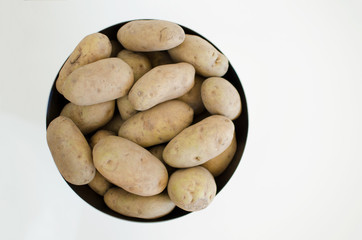 top view of a silver bowl with potatoes