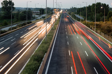 Car traffic lights at evening on a highway