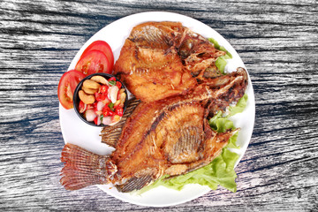 Deep fried Tilapia with spicy and sour herb salad .