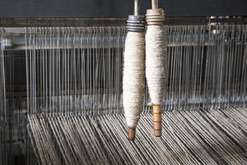 Yarn on bobbins on loom © karenfoleyphoto