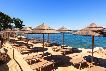 Beach umbrellas in Saint Nicholas island in Porec, Istria. Croatia