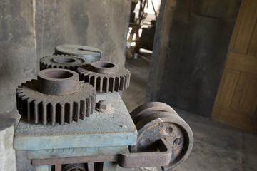 Vintage cogs on dirty machinery in factory