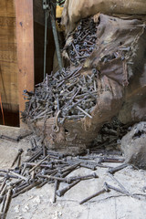 Bags of rusting bolts in attic