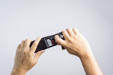 Hand holding classic knife with sheath for hunter who love camping or hiking