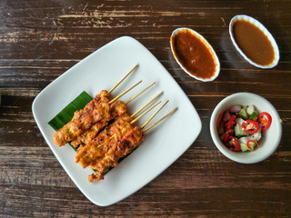 Thai food, grilled pork Satay with peanut sauce and pickles