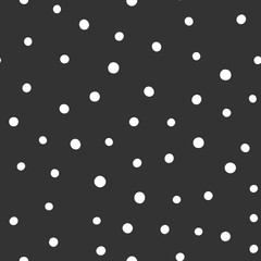 Round white spots on a black background. Seamless pattern with circles drawn by hand.