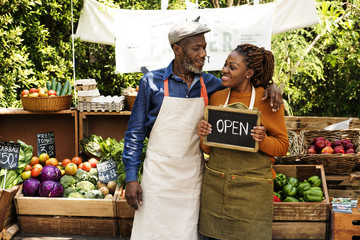 Greengrocer selling organic fresh agricultural product at farmer market