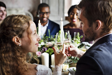 Bride and Groom Clinging Wineglasses Together at Wedding Reception