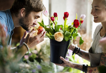 Man Smelling Fresh Flowers in Pot