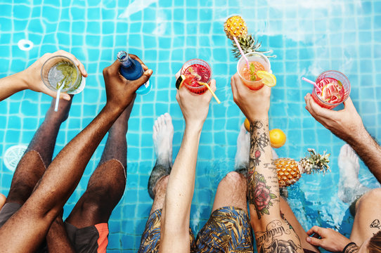 Group of diverse friends enjoying summer time with beverage