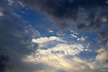 White clouds with some dark clouds in dusk sky