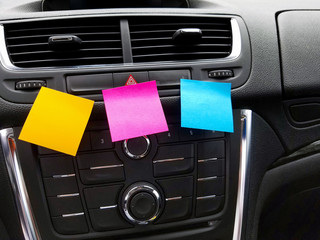 colorful blank sticky notes on car dashboard