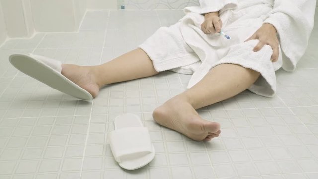 Woman falling in bathroom because slippery surfaces