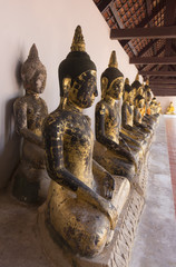 A row of seated Buddhas at a  temple ;South of Thailand