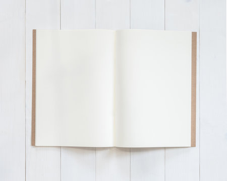 Book mockup template open page  A4-size recycle paper flat lay on white wood table from top view