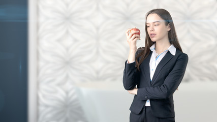 Young beautiful business woman and creative designer standing over blured interior background