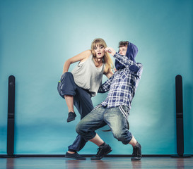 couple of young man and woman dancing hip-hop