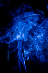 Fototapeta premium Blue toxic fumes movement on a black background.