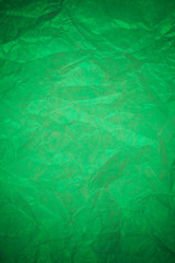 Fototapeta premium Crumpled green paper recycling background.