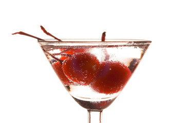 Sparkling water or soda in a glass with a red cherry