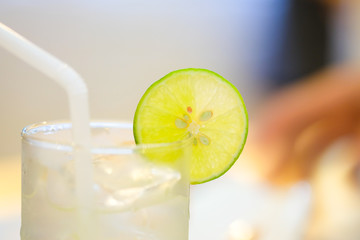 Lemon honey in a glass with lemon slices.