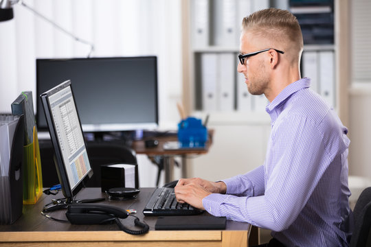 Businessman Using Computer In Office