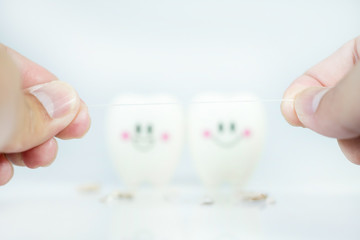 Hand of man holding Dental floss with blur Teeth smile and crying emotion ,Concept Dental care...