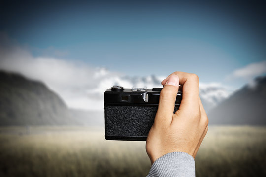 Man taking photo with vintage camera