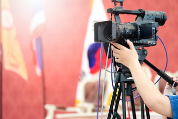 Photographer video recording activity within the event