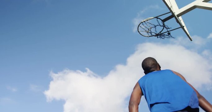 Basketball player scoring a dunk