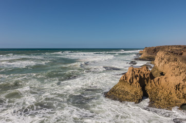 Waves  breaking of cliffs near Oualidia lagoon in same name village in Atlantic ocean coast, Morocco