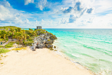 Fototapeta premium Mayan ruins of Tulum at tropical coast. God of Winds Temple at paradise beach. Mayan ruins of Tulum, Quintana Roo, Mexico.