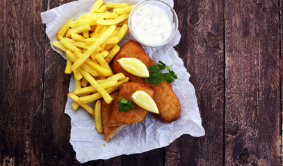 traditional British fish and chips on wooden background