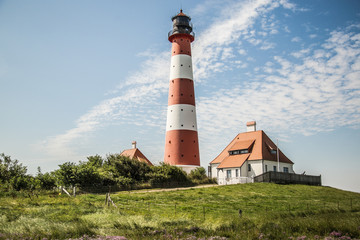 Fototapeta na wymiar Westerhever lighthouse at North Sea coast, Germany 