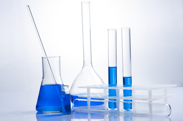 Science laboratory test tubes, equipment filled with blue liquid