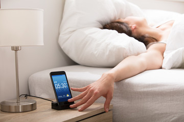 Woman Turning Off The Alarm
