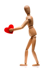 Wooden man holds a red heart