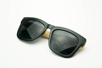 black sunglasses with wooden legs on white background