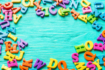 Multiple colored letters on wooden table