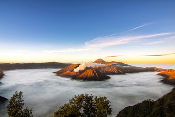 Bromo volcano national park with sunrise sky background and fog landscape