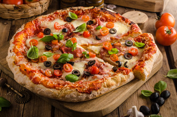 Rustic pizza with tomato, cheese, salami
