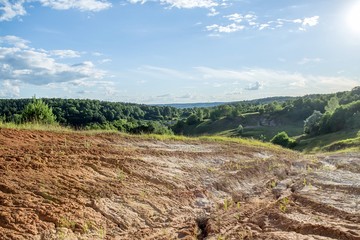 Summer blue sky over a clay quarry