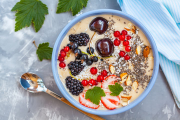 Summer smoothie bowl with berries, coconut and chia seeds. Love for a healthy vegan food concept.